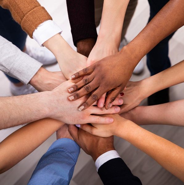 High Angle View Of Multiracial Friend Stacking Hand Together