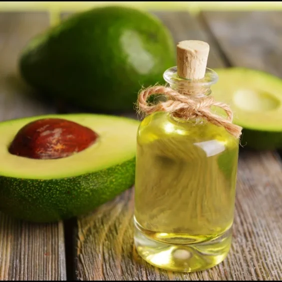 Halfed-Avocado-fruit-and-Avocado-Oil-on-Wooden-Table Halfed-Avocado-fruit-and-Avocado-Oil-on-Wooden-Table